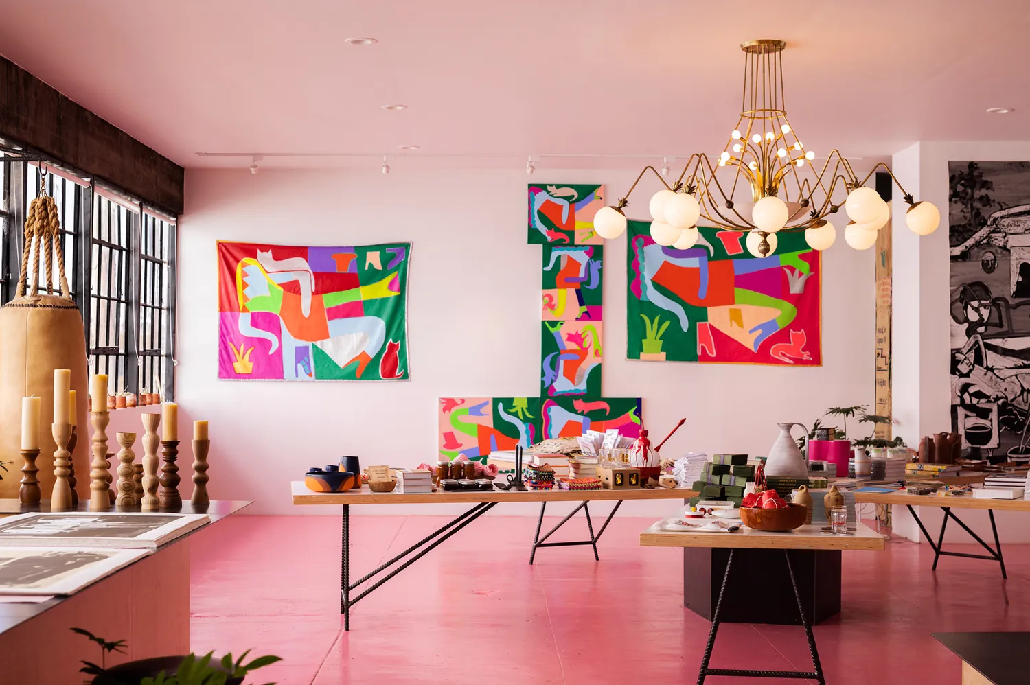 Interior of Wrong Marfa featuring vibrant abstract wall art and curated curios on display tables.