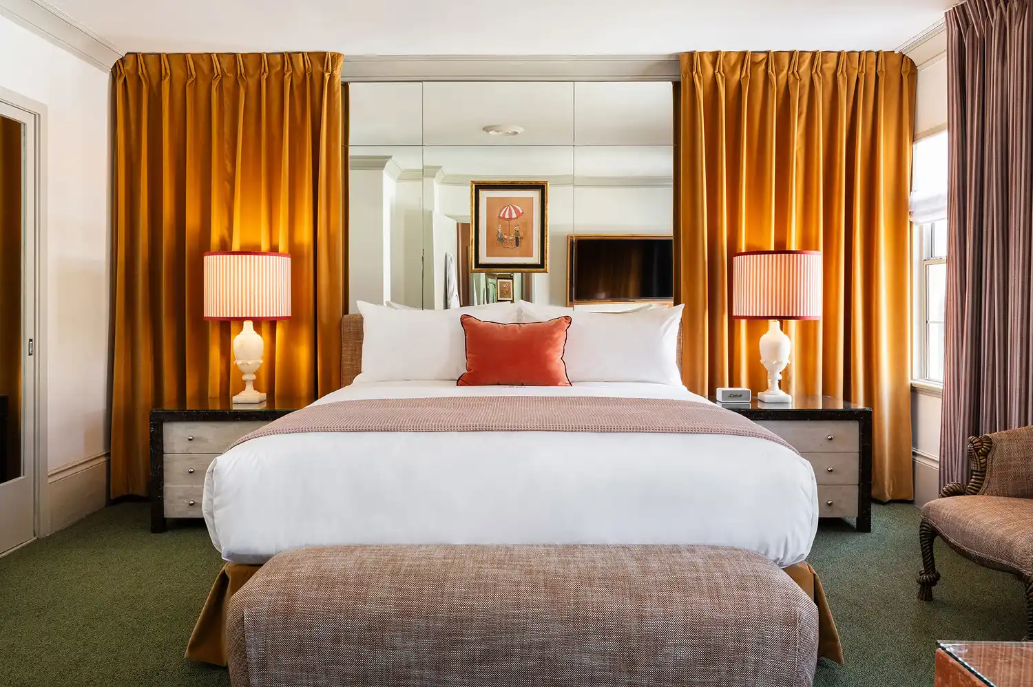 A vintage-inspired hotel guest room at Hôtel Lili with a plush bed and elegant mid-century drapery.