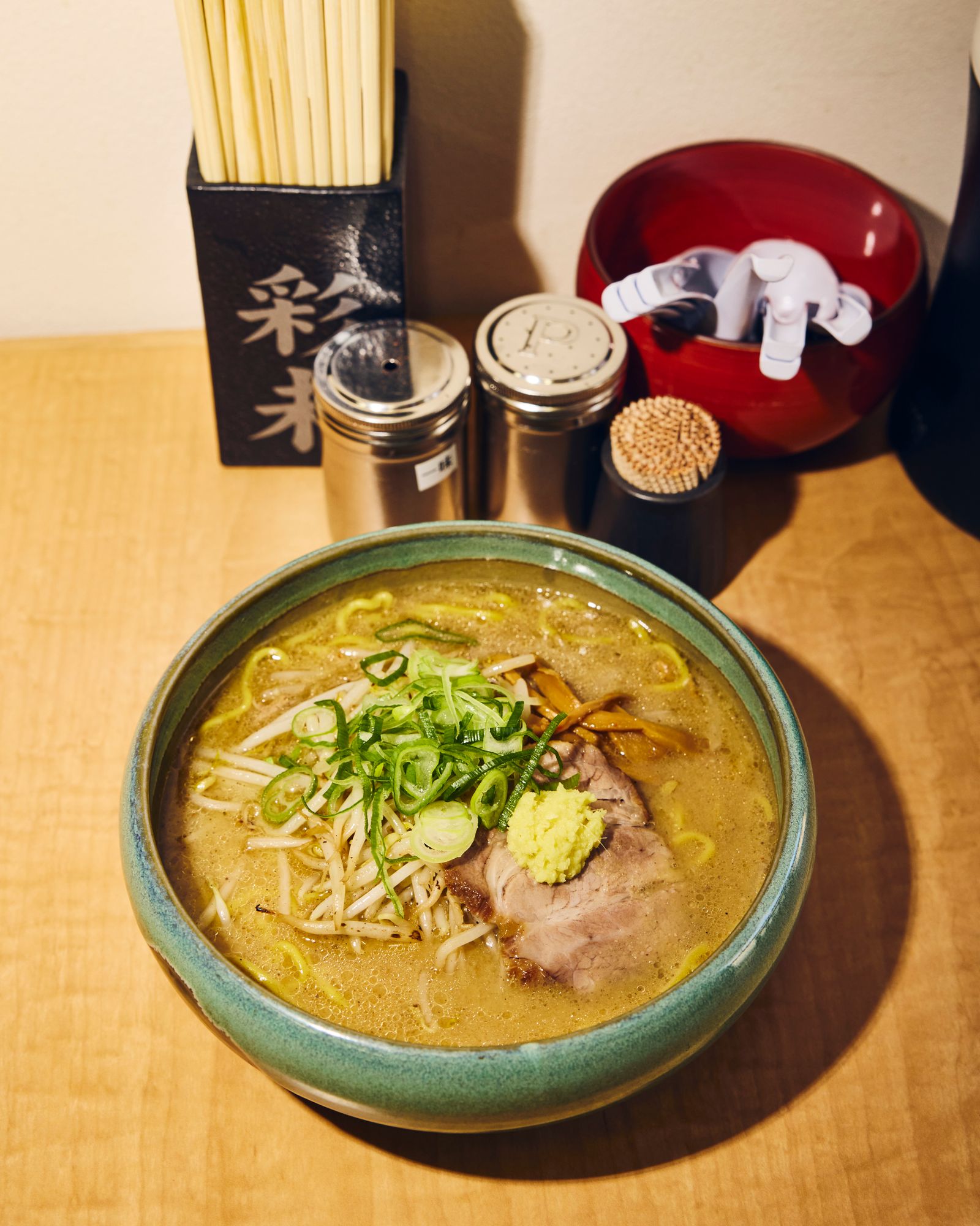 A steaming bowl of miso ramen with rich broth, noodles, and toppings.