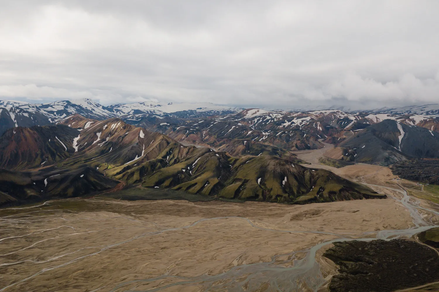 Aerial view of the colorful rhyolite mountains and vast plains of Landmannalaugar.
