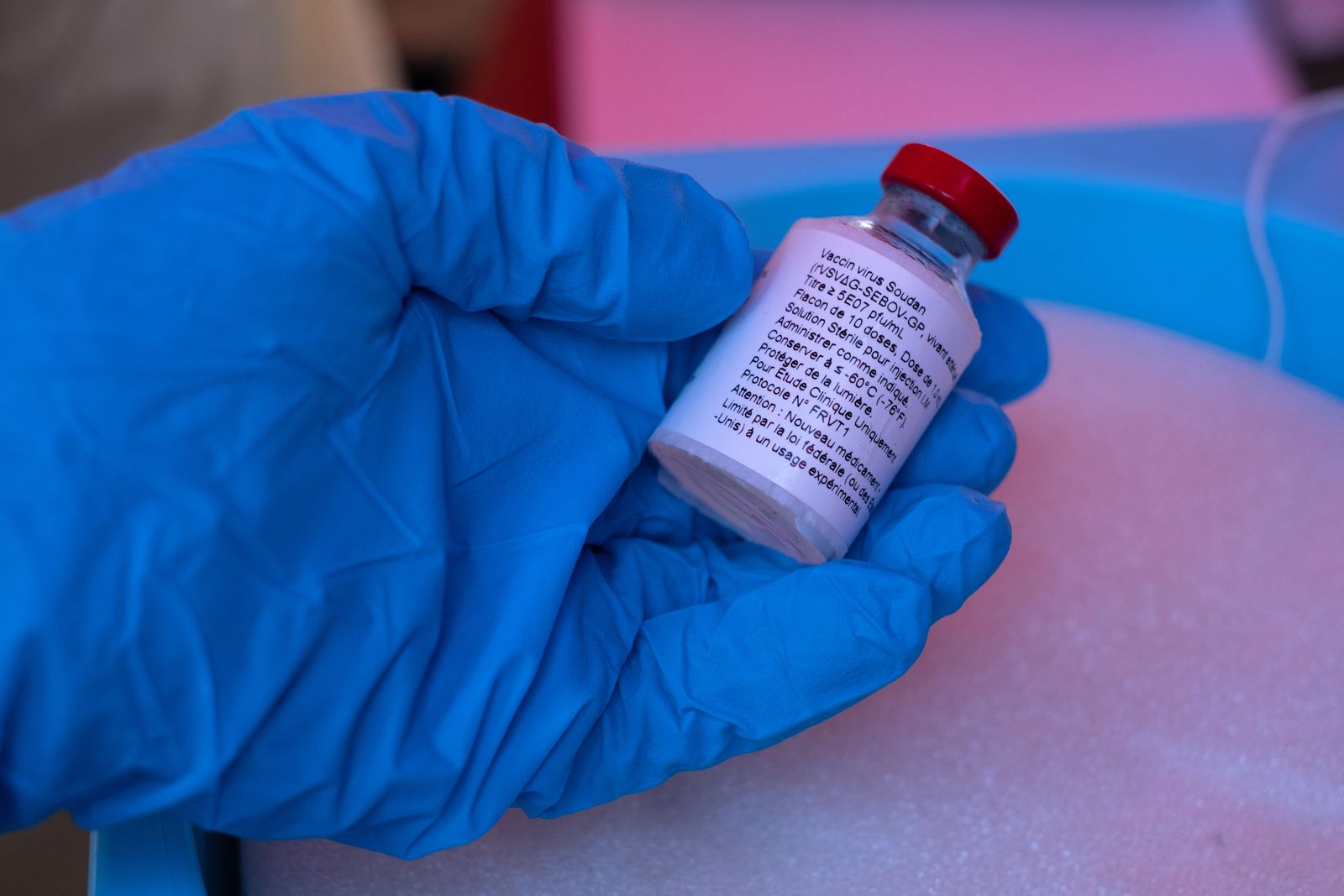 Health worker in protective clothing and gloves preparing for a medical screening.