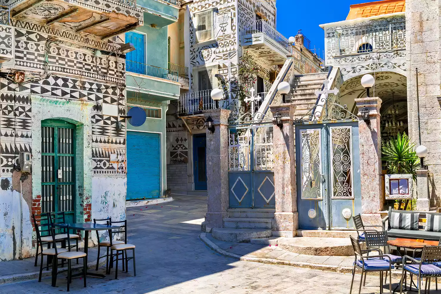 Traditional houses in Pyrgi, Chios, featuring intricate black and white geometric patterns.