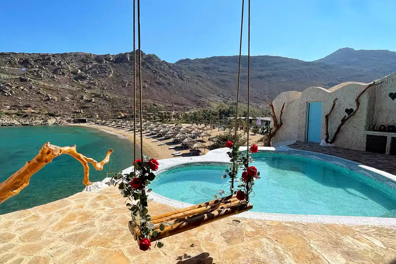 A luxury heart-shaped swimming pool at a resort overlooking the sea in Ios, Greece.