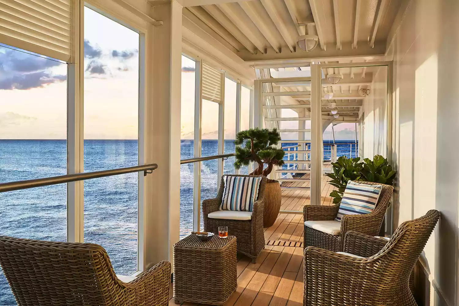 A clean, sophisticated interior lounge deck on the Silver Shadow with comfortable seating and ocean views.