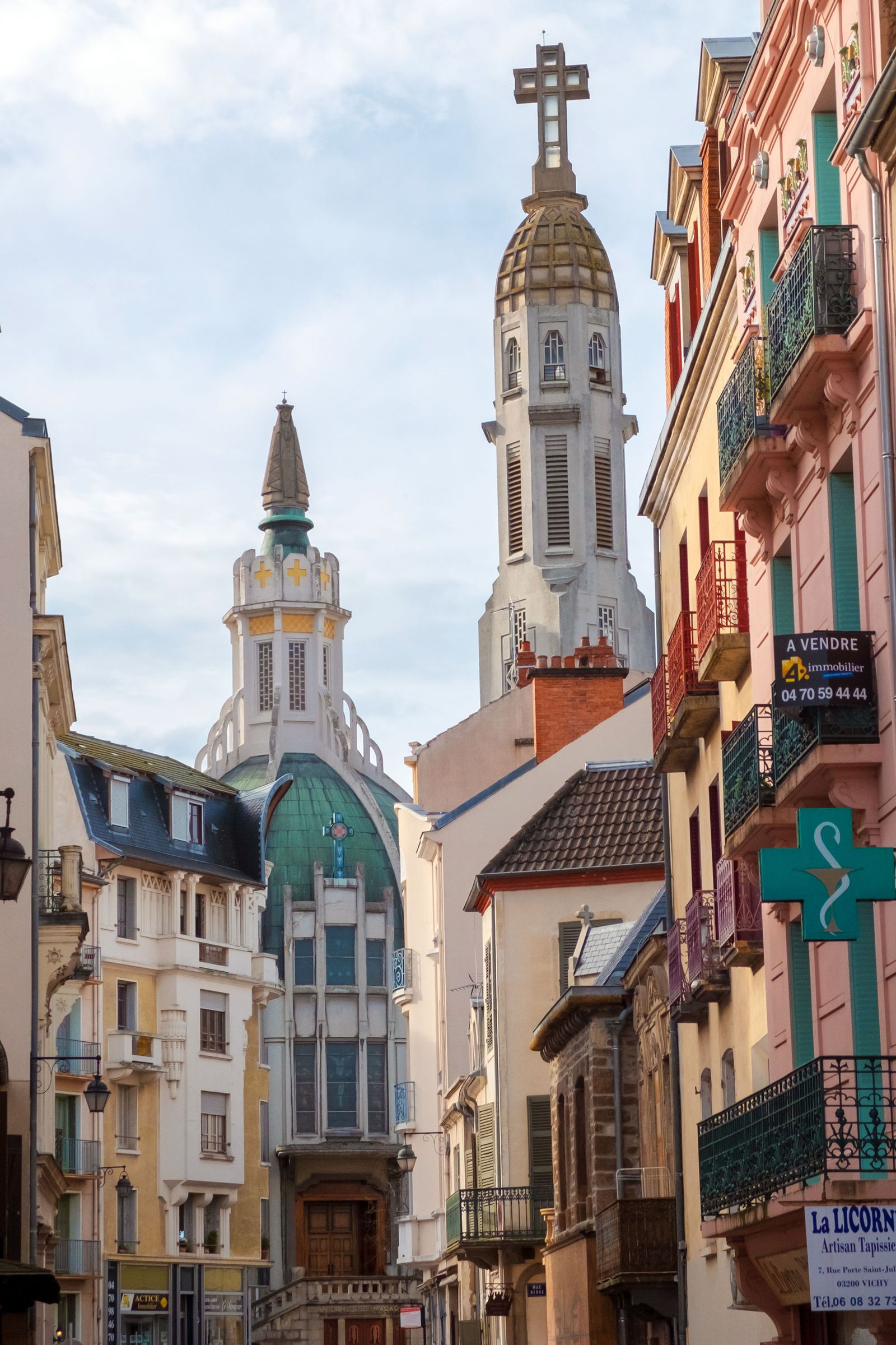 A stone gothic archway featuring a traditional wrought-iron lamp in an ancient building.