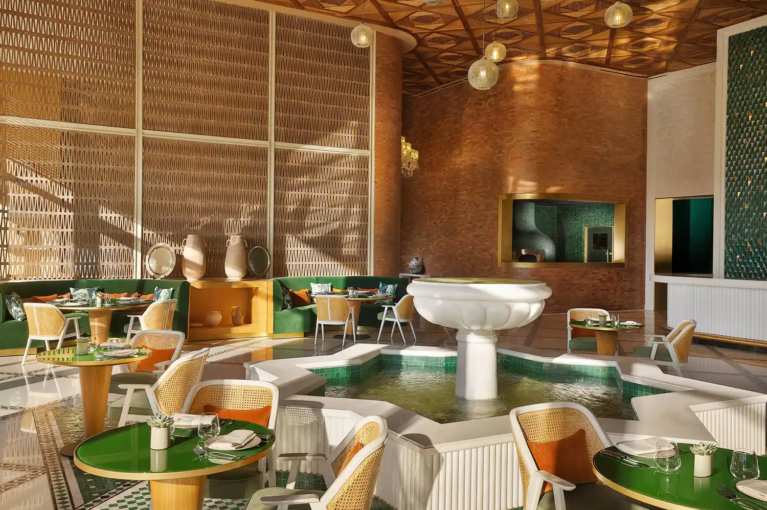 Interior of Brasserie Magnolia featuring a central fountain and traditional Moroccan woven wall panels.