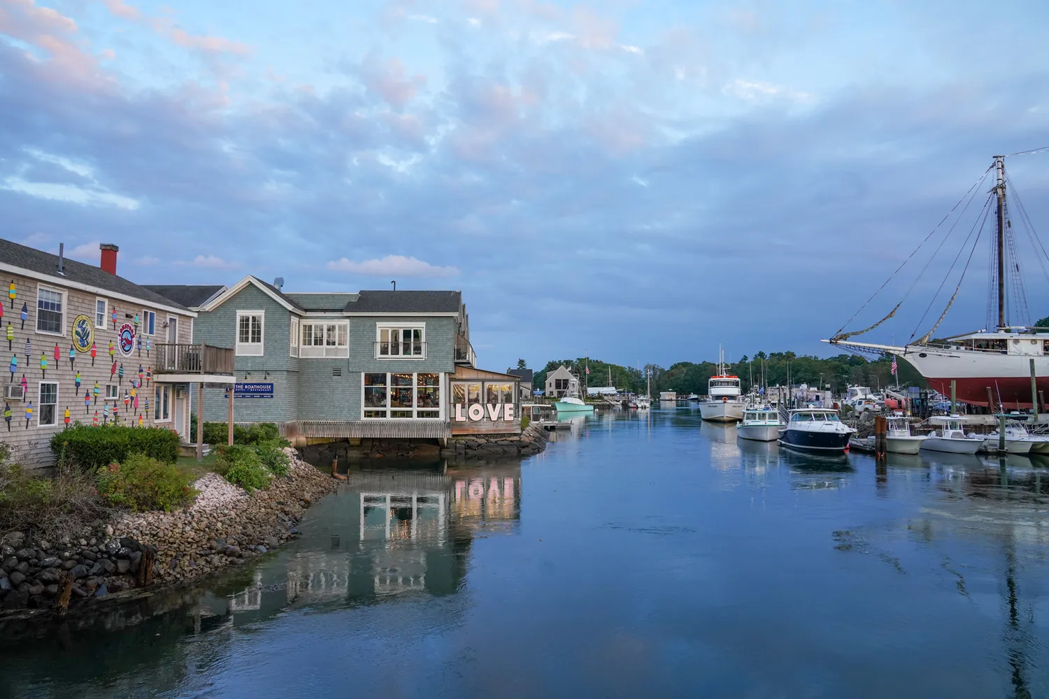 Historical harbor with fishing boats and coastal houses in Kennebunkport, Maine.