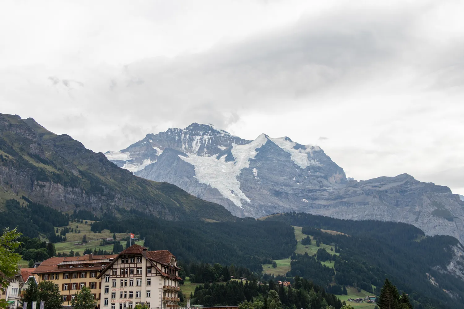 Jagged, snow-covered mountain peaks under a clear blue sky in the Swiss Alps.