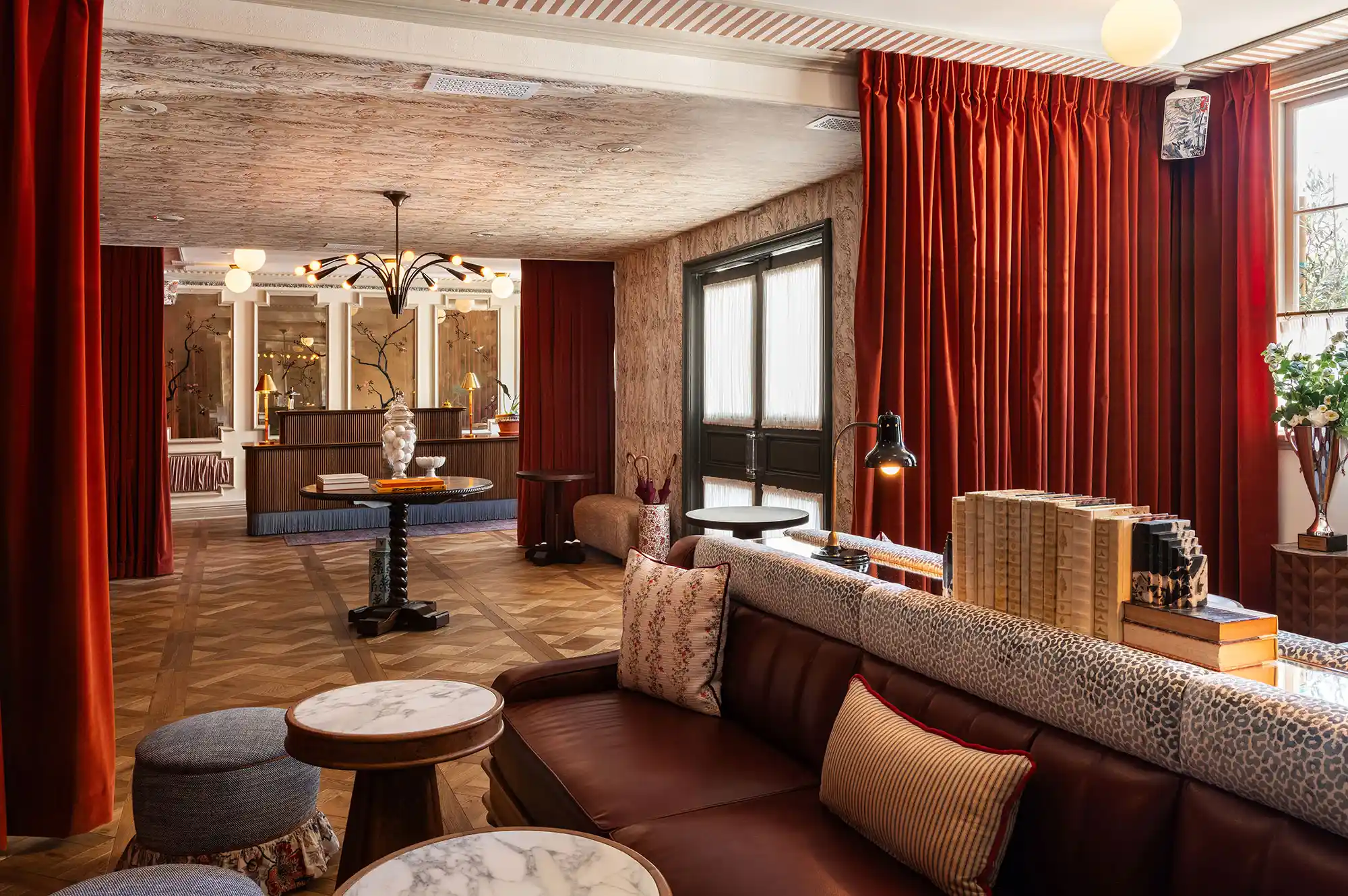 The stylish lobby and seating area of Hôtel Lili with a reception desk in the background.