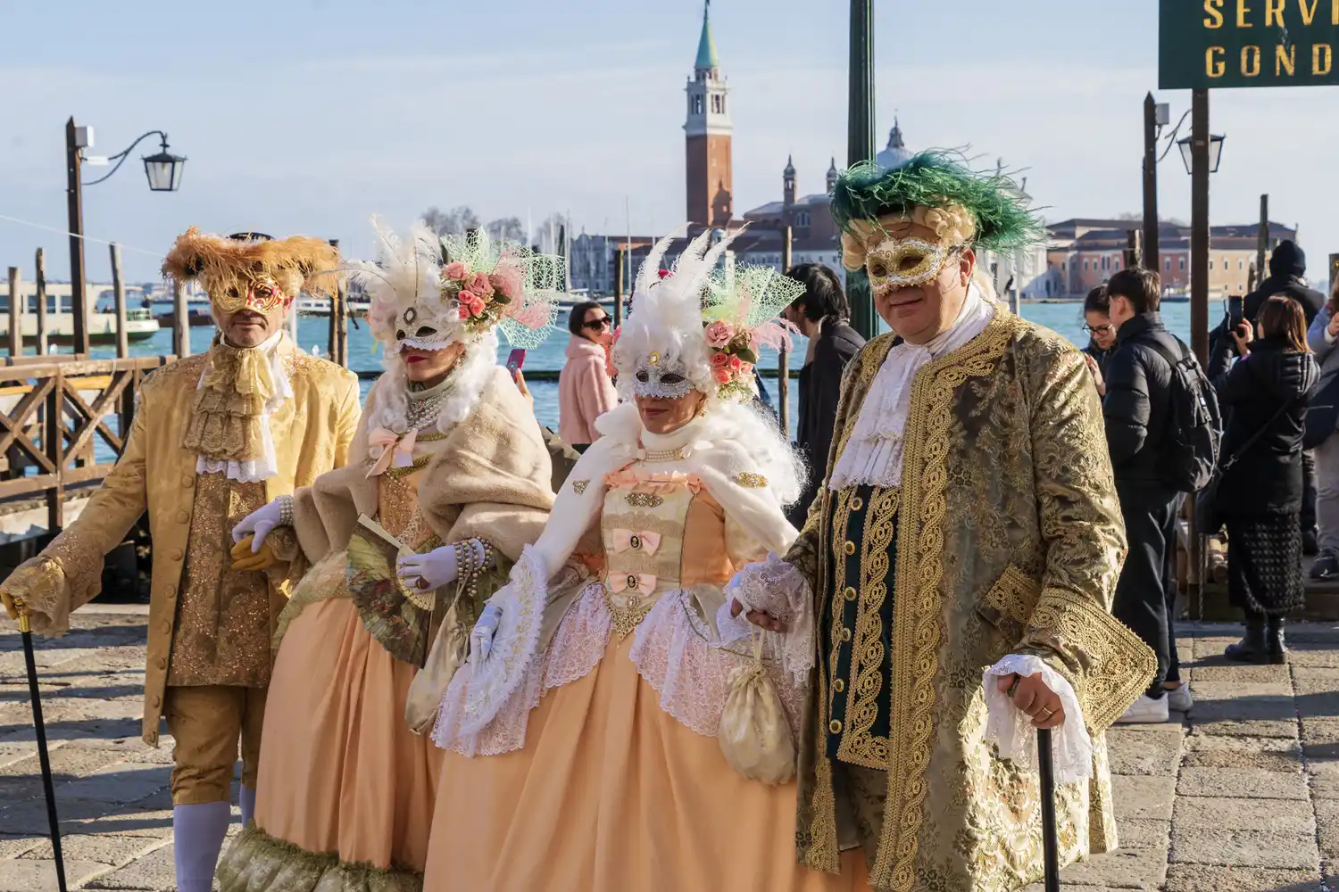 Participants in ornate masks and period costumes at the Venice Carnival.