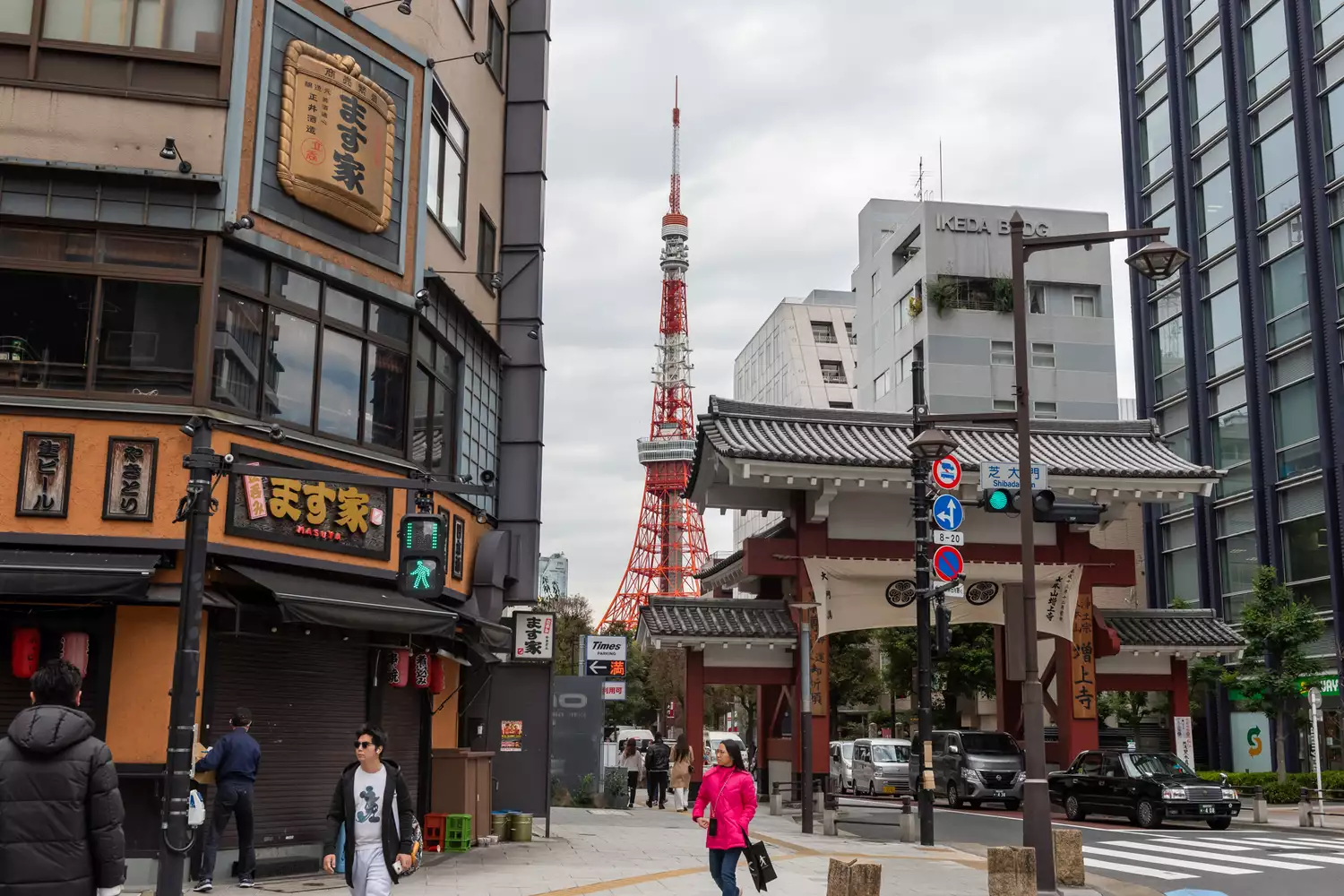 A vibrant street view in Tokyo featuring the Tokyo Tower in the background.