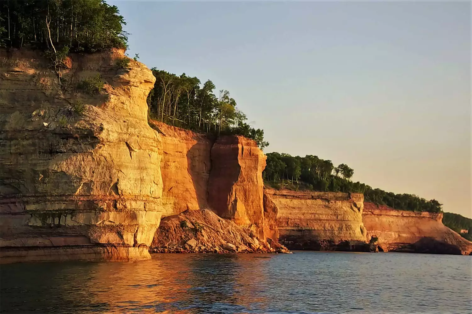 Dramatic vertical sandstone cliffs of Pictured Rocks overlooking Lake Superior in Munising.