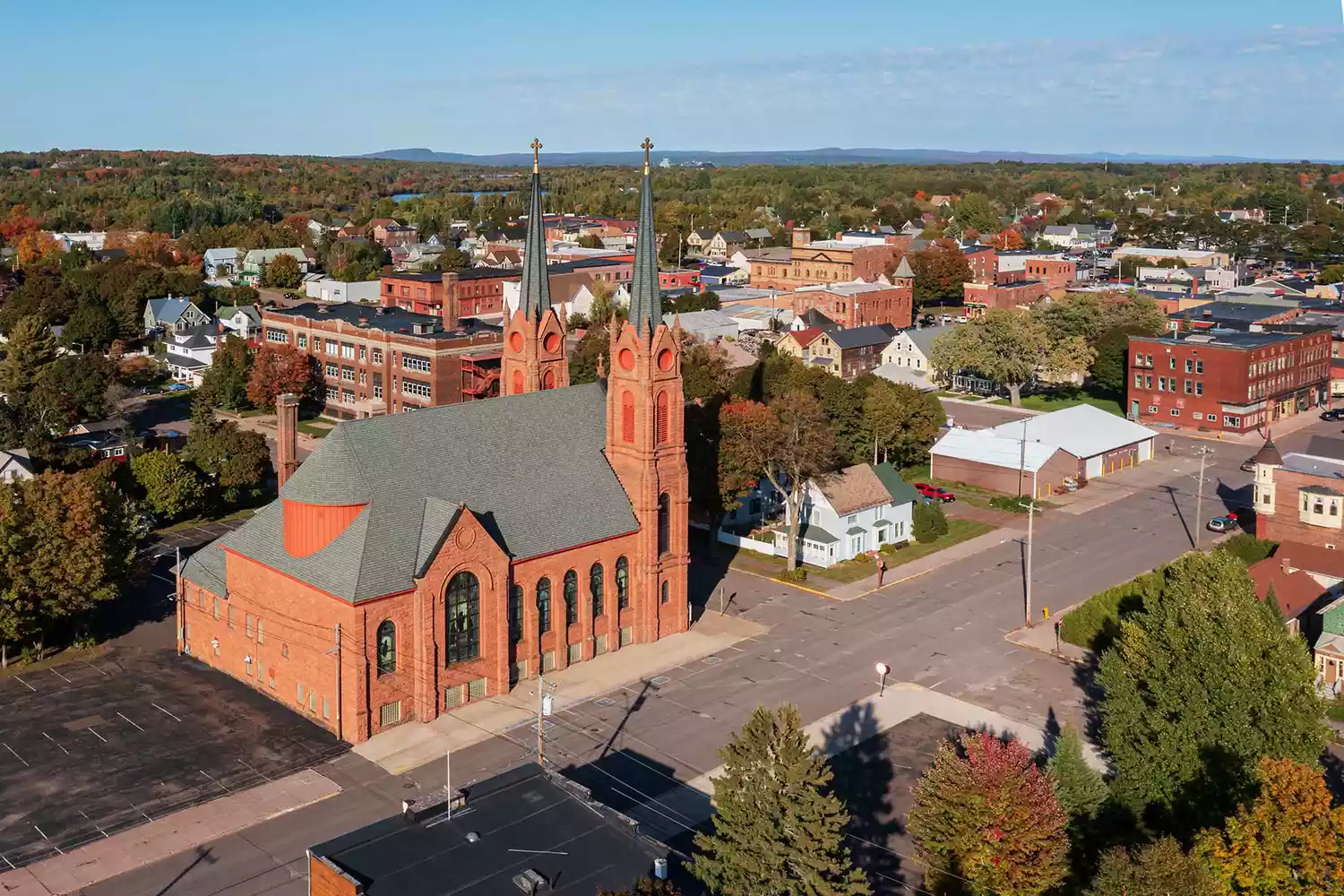 Aerial perspective of the historic churches and red-brick buildings in downtown Calumet.