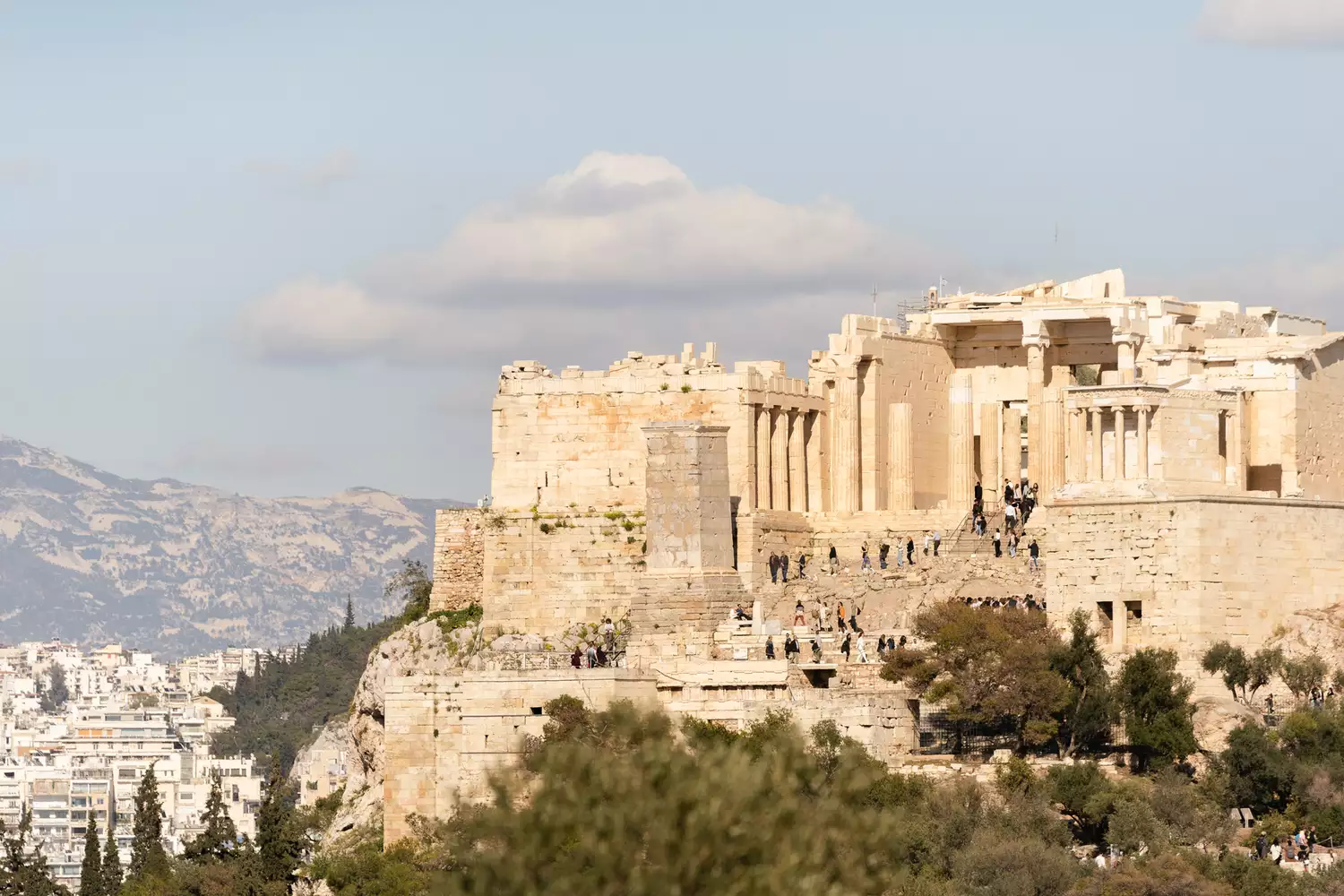 The ancient Acropolis of Athens and the Parthenon under a bright, sunny sky.