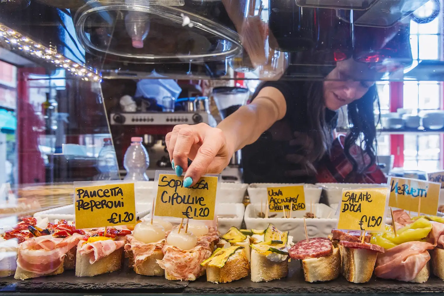 An array of Italian cicchetti appetizers displayed at a food counter.