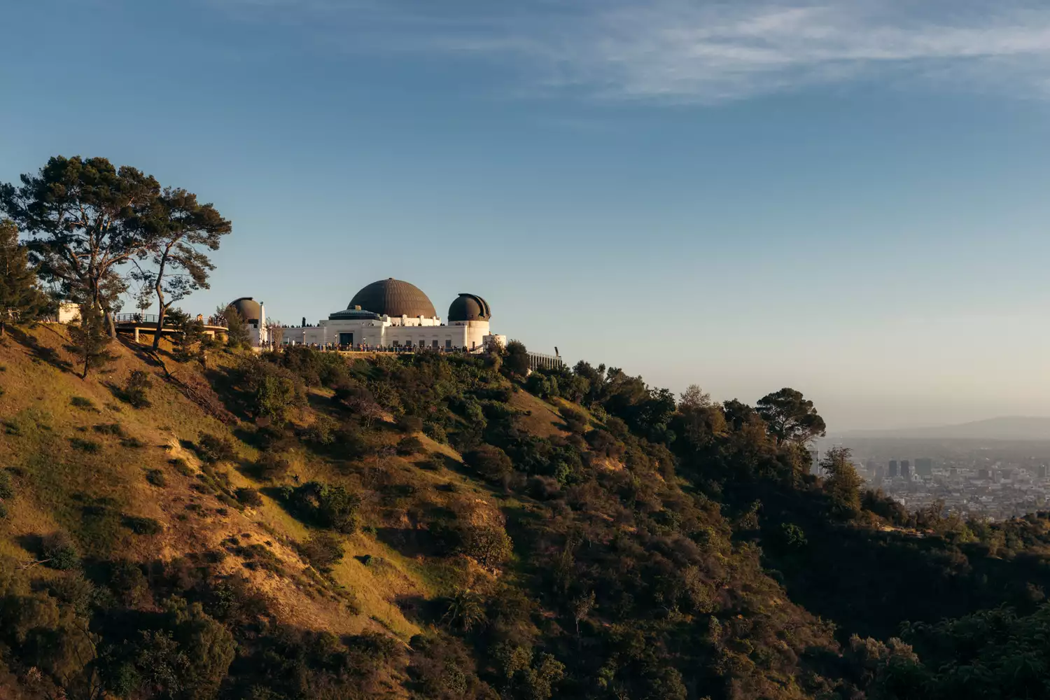 The white domes of the Griffith Observatory overlooking the sprawling Los Angeles skyline.