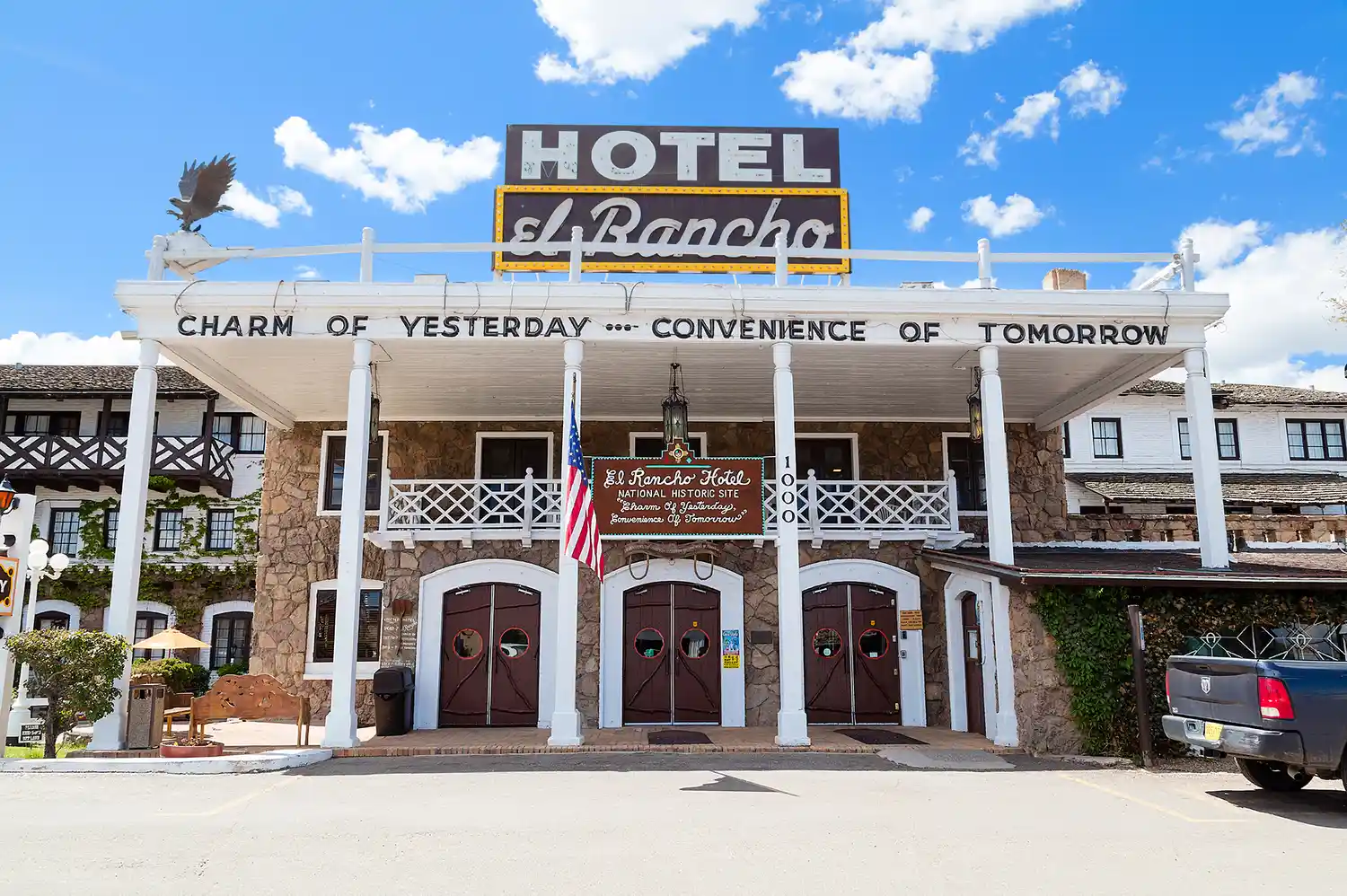 Front facade of the El Rancho Hotel in Gallup, New Mexico, with its historic slogan visible.