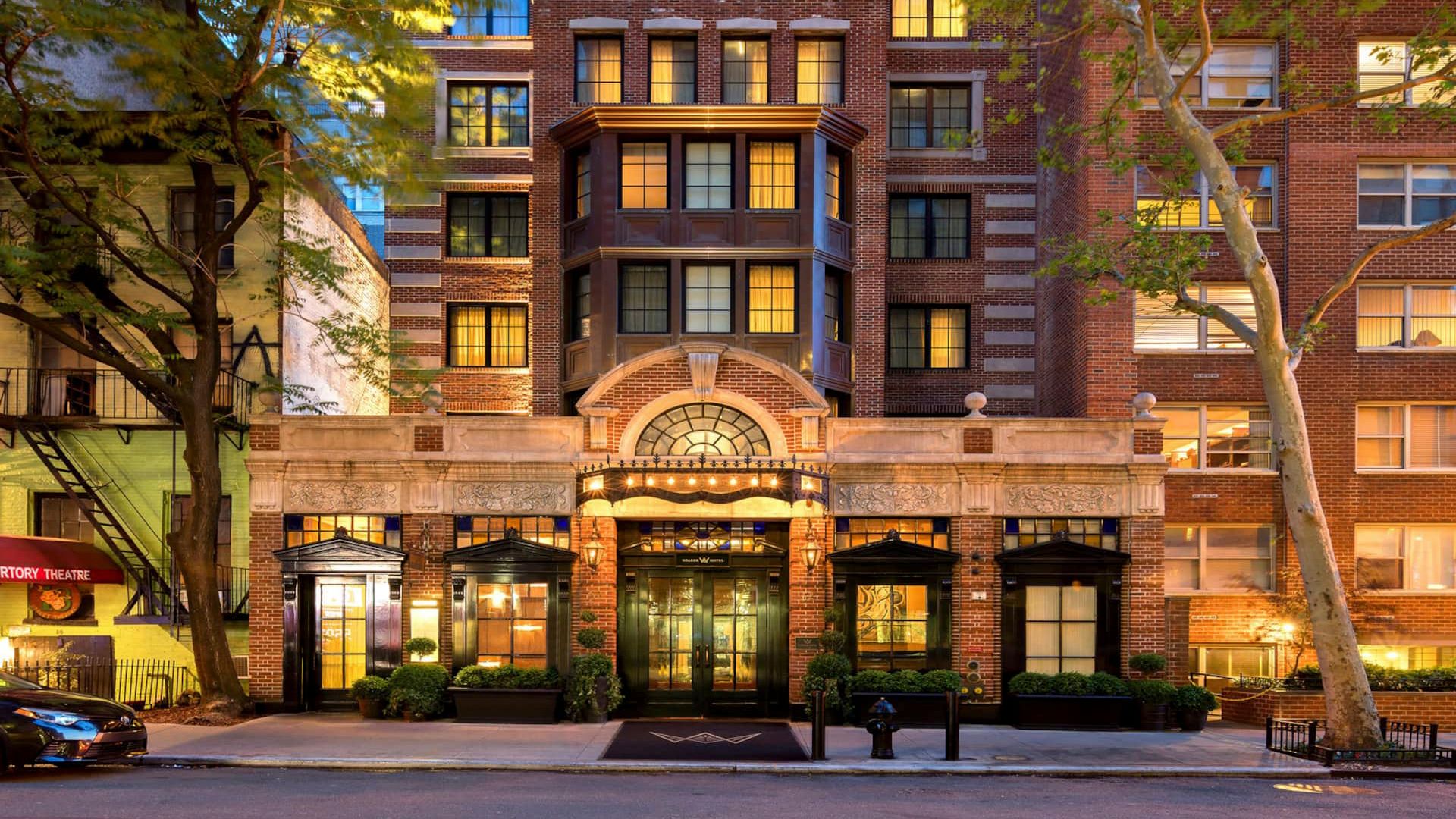 New York City urban architecture featuring high-rise apartment and hotel buildings against a clear sky.