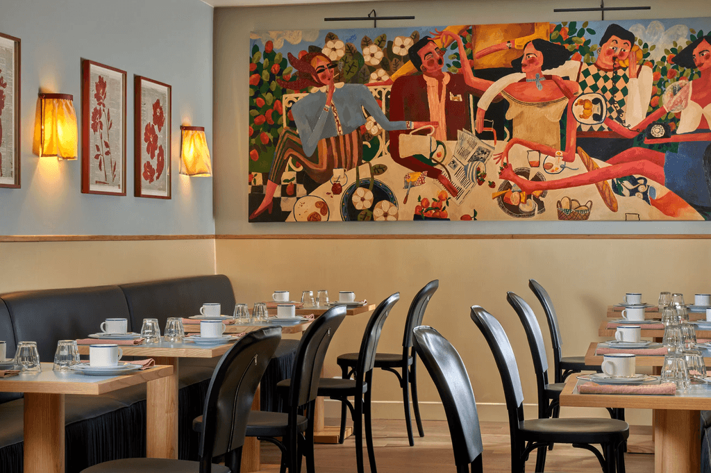 Whimsical hotel interior with handwoven tapestry headboards and vibrant green tiles.
