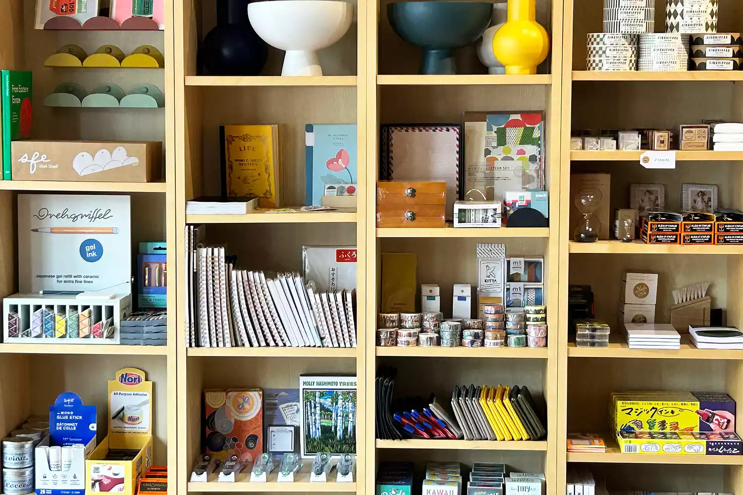 Neatly organized display shelves inside the Modern Love boutique featuring various gift items and stationery.