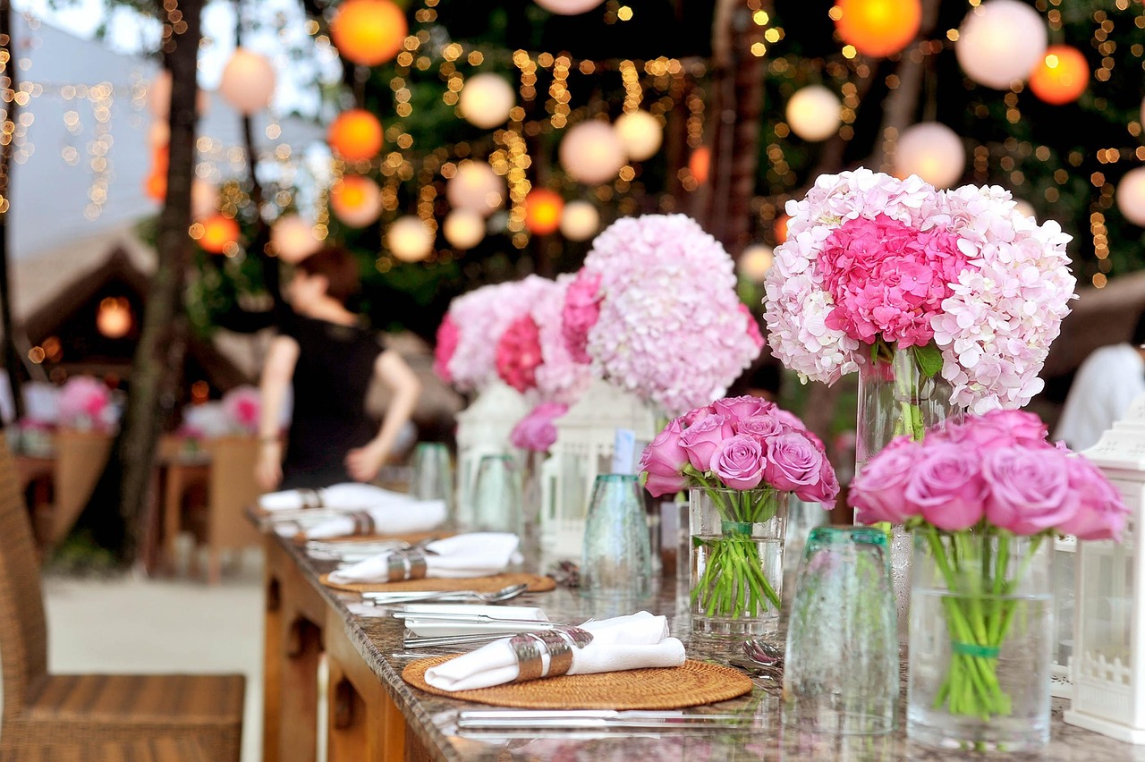 Custom-constructed furniture and hanging floral installations bring the 'Enchanted Garden' theme to life.