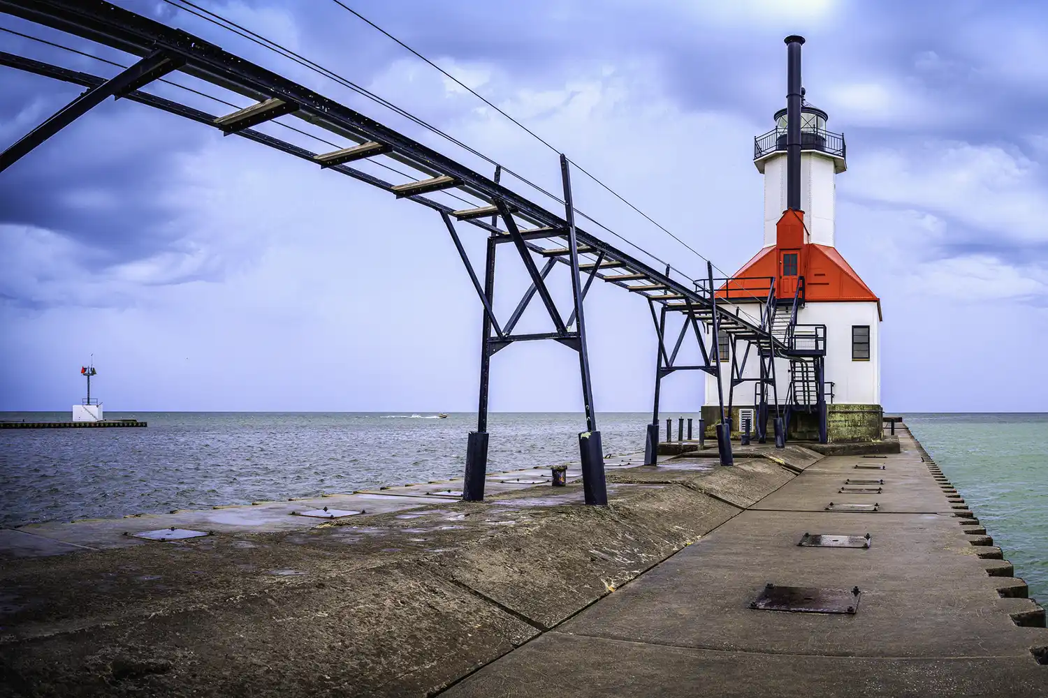 The historic St. Joseph North Pier Inner Lighthouse during a clear day on Lake Michigan.